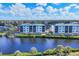 Aerial view of waterfront condominiums with lush landscaping and stunning water views at 9203 Griggs Rd # 204, Englewood, FL 34224