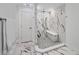 Bathroom boasts a shower with marble walls, pebble floor, and a built-in seat at 9203 Griggs Rd # 204, Englewood, FL 34224
