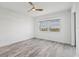 Serene bedroom features light-colored wood floors and a window with scenic outside views at 9203 Griggs Rd # 204, Englewood, FL 34224
