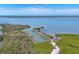 Aerial view of boat docks on the water, with boats docked, surrounded by lush greenery at 9203 Griggs Rd # 204, Englewood, FL 34224