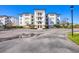 Beautiful building exterior with detailed architecture, balconies, and a spacious parking lot at 9203 Griggs Rd # 204, Englewood, FL 34224
