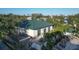 Modern building exterior with a green roof, patio seating, and well-maintained landscaping at 9203 Griggs Rd # 204, Englewood, FL 34224