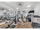 Well-equipped fitness center with modern exercise machines, mirrors, and a TV for workouts at 9203 Griggs Rd # 204, Englewood, FL 34224