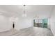 Spacious living room with wood flooring, access to the balcony, and ample natural light at 9203 Griggs Rd # 204, Englewood, FL 34224