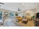 Inviting living room with comfortable sofas, tile flooring, and seamless access to an outdoor patio area at 9203 Griggs Rd # 204, Englewood, FL 34224