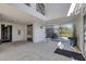 Inviting lobby area with tiled floors, secure access gate, elevator, and comfortable seating at 9203 Griggs Rd # 204, Englewood, FL 34224