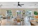 Bright and airy lounge area with comfortable seating, dining tables, and access to outdoor patios at 9203 Griggs Rd # 204, Englewood, FL 34224