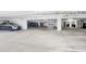 A parking garage with several parking spaces and parked cars at 9203 Griggs Rd # 204, Englewood, FL 34224