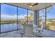 Inviting screened patio boasts water views, a ceiling fan, and outdoor seating at 9203 Griggs Rd # 204, Englewood, FL 34224