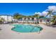 Beautiful community pool area with lounge chairs and lush landscaping at 9203 Griggs Rd # 204, Englewood, FL 34224