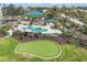Aerial view of community putting green and pool area surrounded by lush landscaping and well-maintained lawns at 9203 Griggs Rd # 204, Englewood, FL 34224