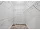 A walk-in closet with white wire shelving on all sides and wood-look flooring at 9203 Griggs Rd # 204, Englewood, FL 34224