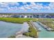 Aerial view of community condominiums alongside a boat dock, with waterway views and lush greenery at 9203 Griggs Rd # A204, Englewood, FL 34224