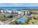 Aerial view of multiple condominiums with ocean view and tennis courts at 9203 Griggs Rd # A204, Englewood, FL 34224