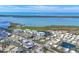 Aerial view of community condominiums and nearby single Gathering homes with beautiful blue water views at 9203 Griggs Rd # A204, Englewood, FL 34224