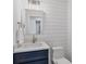 Stylish half-bath with shiplap walls, modern vanity, and updated lighting at 9203 Griggs Rd # A204, Englewood, FL 34224