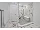 Modern bathroom with walk-in shower, bench seat and black and white marble design at 9203 Griggs Rd # A204, Englewood, FL 34224