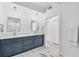 Modern bathroom features double sink vanity with white marble countertop at 9203 Griggs Rd # A204, Englewood, FL 34224