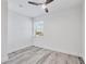 Bedroom showcasing wood-look floors, neutral paint, and modern ceiling fan at 9203 Griggs Rd # A204, Englewood, FL 34224