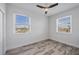 Bedroom with wood-look floors, neutral paint and dual windows with exterior views at 9203 Griggs Rd # A204, Englewood, FL 34224