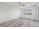 Bright bedroom featuring wood-look floors and large windows with water views at 9203 Griggs Rd # A204, Englewood, FL 34224