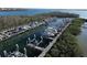 Aerial view of community boat docks, with boat lifts and docks over calm water at 9203 Griggs Rd # A204, Englewood, FL 34224