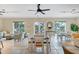Bright community room with tile floors, ceiling fans, dining tables, and comfortable seating at 9203 Griggs Rd # A204, Englewood, FL 34224