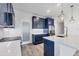 The kitchen boasts navy cabinets, stainless appliances and a white countertop at 9203 Griggs Rd # A204, Englewood, FL 34224