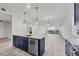 Bright, modern kitchen features a central island with pendant lighting and stainless steel appliances at 9203 Griggs Rd # A204, Englewood, FL 34224
