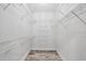 Walk-in closet features wire shelving and wood-look floors at 9203 Griggs Rd # A204, Englewood, FL 34224
