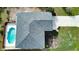 Aerial view of the home showcasing the pool, roof, driveway, and landscaping at 9265 Carnation Ave, Englewood, FL 34224