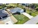 Aerial view of the property and surrounding neighborhood with mature trees at 9265 Carnation Ave, Englewood, FL 34224