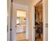 Bright bathroom with modern vanity, large mirror, and tiled flooring, alongside an open closet at 9265 Carnation Ave, Englewood, FL 34224