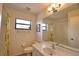 A bathroom featuring a large mirror, neutral tile, and floral shower curtain at 9265 Carnation Ave, Englewood, FL 34224