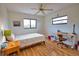 A bright bedroom with hardwood floors, ceiling fan, and a cozy quilt at 9265 Carnation Ave, Englewood, FL 34224
