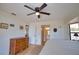 Bedroom with a light wood floor and a door that leads to the ensuite bathroom at 9265 Carnation Ave, Englewood, FL 34224