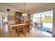 Dining area with views to the pool and outside with wooden china cabinet at 9265 Carnation Ave, Englewood, FL 34224