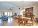 Open floor plan with dining area leading into the living room, full of natural light at 9265 Carnation Ave, Englewood, FL 34224