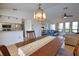 Dining area with hanging chandelier, connecting to the kitchen and the living room at 9265 Carnation Ave, Englewood, FL 34224