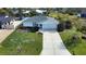 Well maintained single Gathering home with lush green grass and landscaping in front yard at 9265 Carnation Ave, Englewood, FL 34224