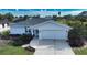 Charming single-story home with a well-manicured lawn and attached two car garage at 9265 Carnation Ave, Englewood, FL 34224