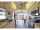 Spacious kitchen with stainless steel appliances and a ceiling fan at 9265 Carnation Ave, Englewood, FL 34224