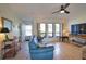 Bright living room with large windows, tile flooring, and comfortable seating area at 9265 Carnation Ave, Englewood, FL 34224
