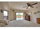 Main bedroom with a ceiling fan, sliding glass doors and view of pool at 9265 Carnation Ave, Englewood, FL 34224