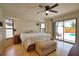 Bright main bedroom features a ceiling fan, an exterior door to the pool and an ensuite at 9265 Carnation Ave, Englewood, FL 34224
