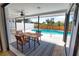 Covered patio with view of pool area, seating, and ceiling fan at 9265 Carnation Ave, Englewood, FL 34224