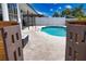 Backyard pool with patio, seen through open wood fence at 9265 Carnation Ave, Englewood, FL 34224