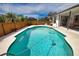 Backyard pool with patio, surrounded by a well-maintained yard, perfect for outdoor enjoyment at 9265 Carnation Ave, Englewood, FL 34224