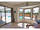 Sun room with tile flooring and large windows overlooking the pool area at 9265 Carnation Ave, Englewood, FL 34224