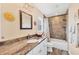 Bathroom with a granite countertop, white cabinets, and a shower with decorative tile at 97 Kettle Harbor Dr, Placida, FL 33946